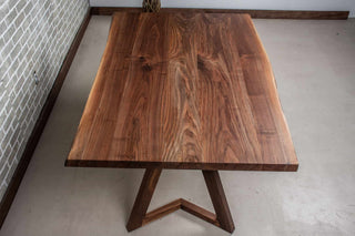 calm live edge walnut table on walnut chevron legs