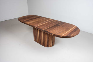 extendable oval table in walnut on a fluted walnut pedestal base