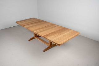 extendable oak dining table on traditional trestle base