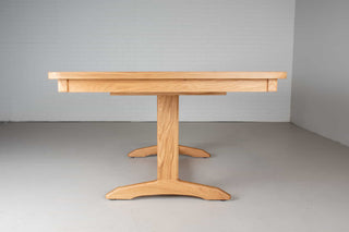 extendable oak dining table on traditional trestle base