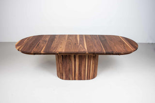 extendable oval table in walnut on a fluted walnut pedestal base