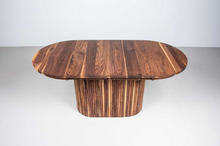 extendable oval table in walnut on a fluted walnut pedestal base