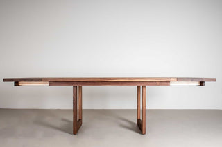 extendable walnut table on mid century modern legs