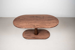 brick colored maple oval table on pedestal base