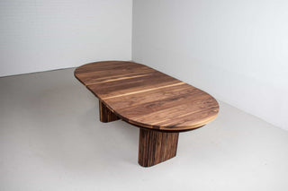 mid century extendable oval table on fluted walnut legs