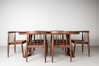 mid century modern extendable dining table made of walnut with matching chairs