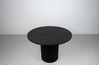mid century modern round black dining table on fluted pedestal base