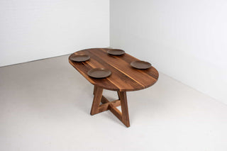 mid century oval table in walnut on single cross pedestal base