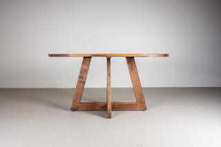 mid century oval table in walnut on single cross pedestal base