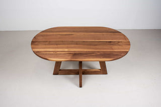 mid century oval table in walnut on single cross pedestal base