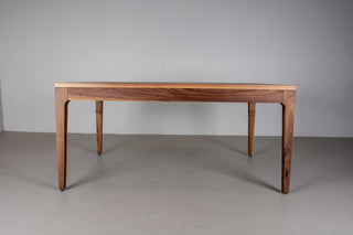 minimalist walnut dining table with a custom parsons base that is flush with the table top and has tapered legs