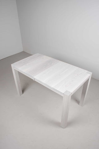 narrow extendable white ash dining table on modern parsons base