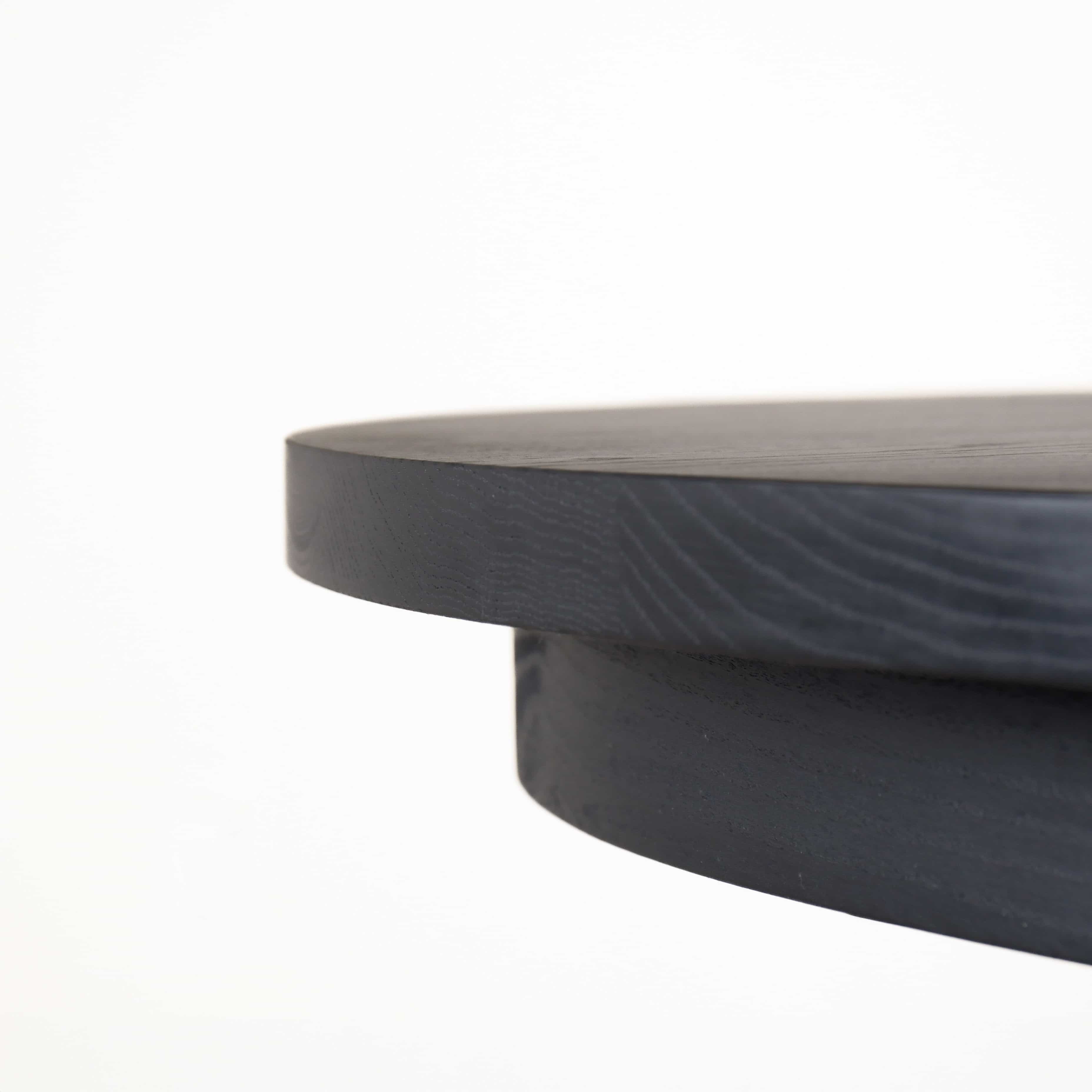 close up of a Seymour edge on a black round oak table