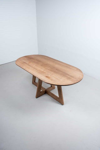 oval maple table finished in coconut on pedestal base