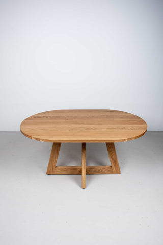 oval white oak table on single cross pedestal base