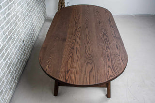 oval oak table on wood legs all finished in espresso