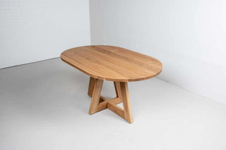 oval white oak dining table on single cross pedestal base