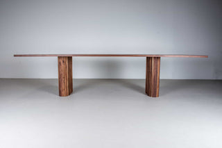 large walnut table on walnut pillar legs