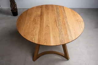 round oak table on curved chevron legs