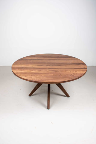 round walnut table on midcentury style base