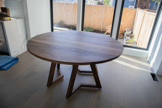 round walnut table on leg pedestal base