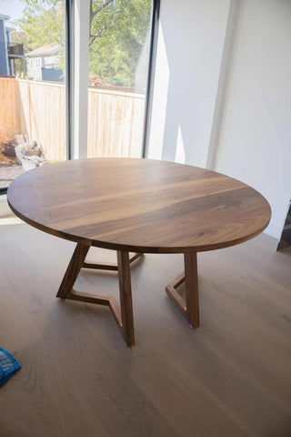 round walnut table on 3 leg pedestal base