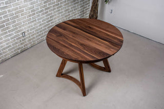 extendable round walnut table on walnut legs