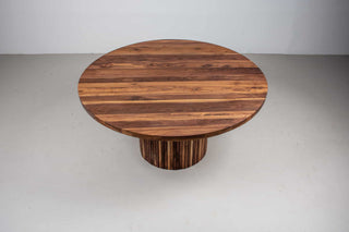 round walnut table on fluted walnut pedestal base
