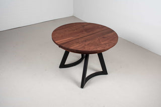 round expandable spiced walnut table on black maple chesbro legs