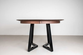 midcentury round walnut extending table with leaves on steel chandler legs