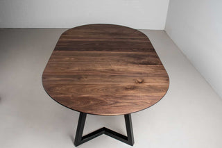 midcentury round walnut extending table with leaves on steel chandler legs