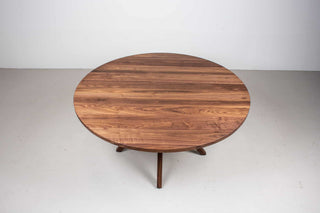 round walnut table on midcentury base