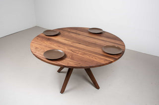 round walnut table on midcentury base