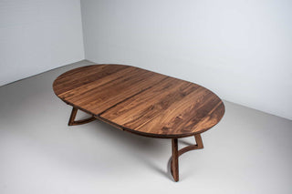 large round walnut expandable table on chesbro legs with hamelin edge