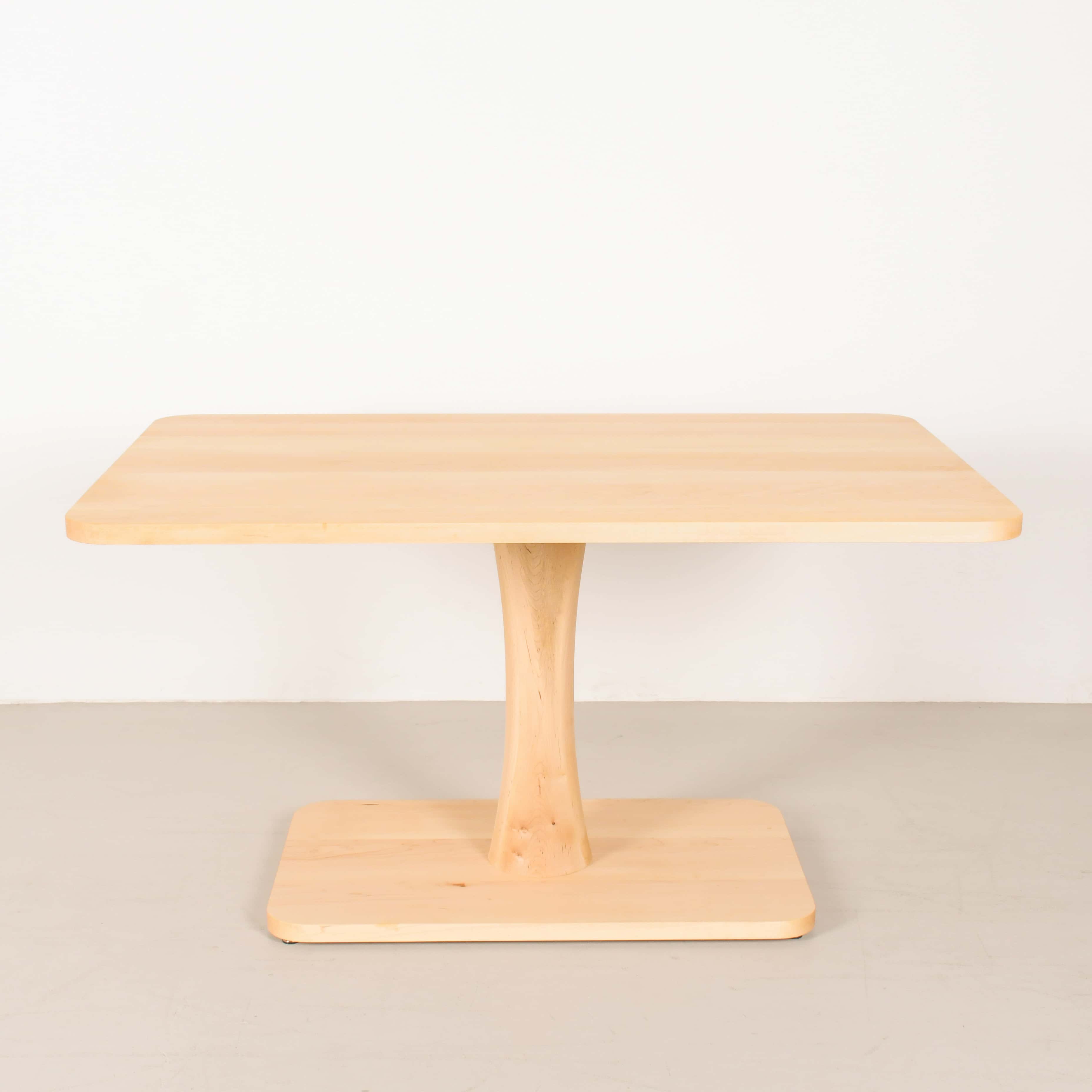Wooden pedestal table for a small dining space