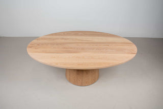 solid oak elliptical dining table on pedestal base