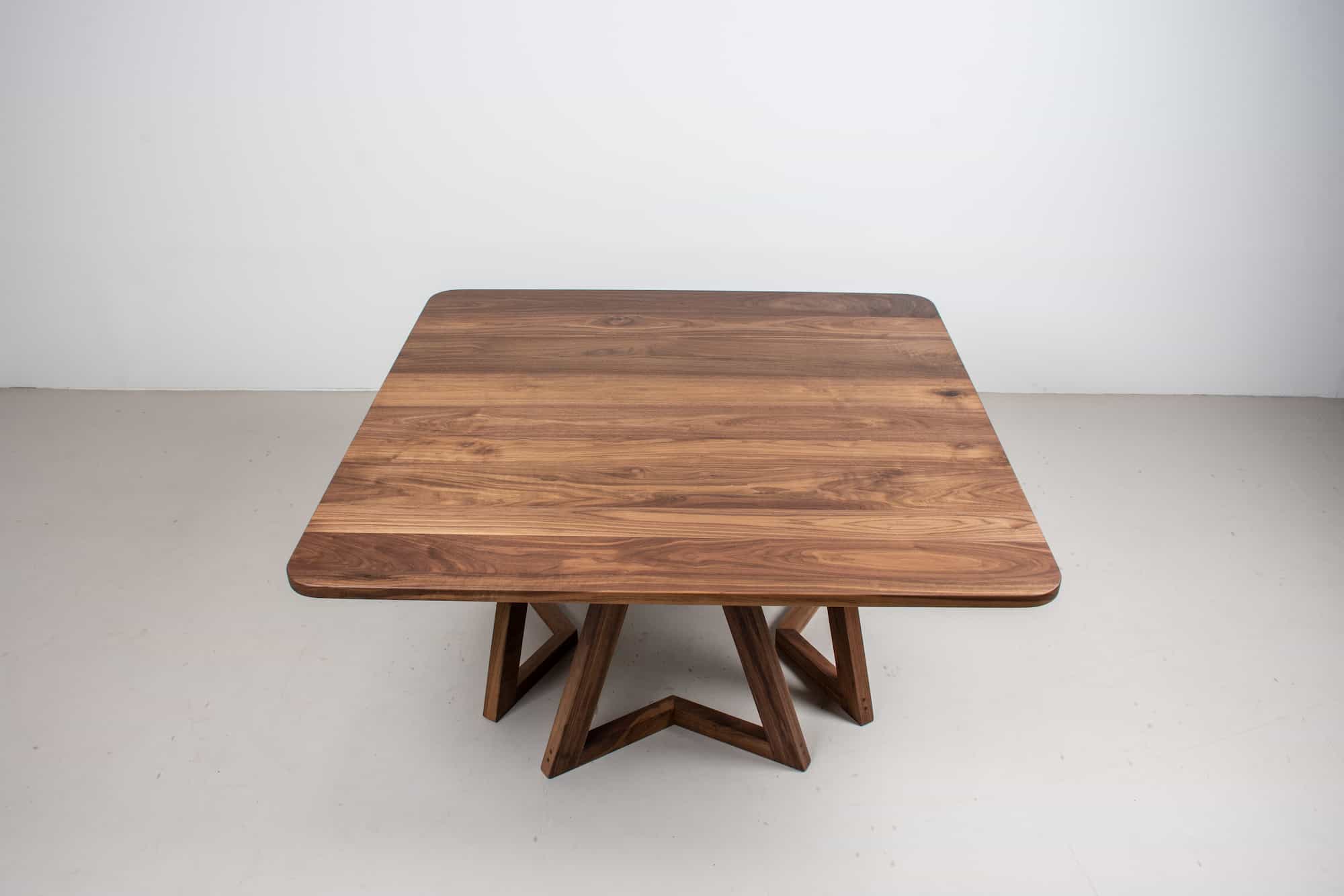 square walnut table on 4 walnut chevron legs