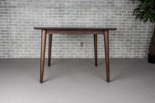 square blackened walnut extendable table on mid century parsons base
