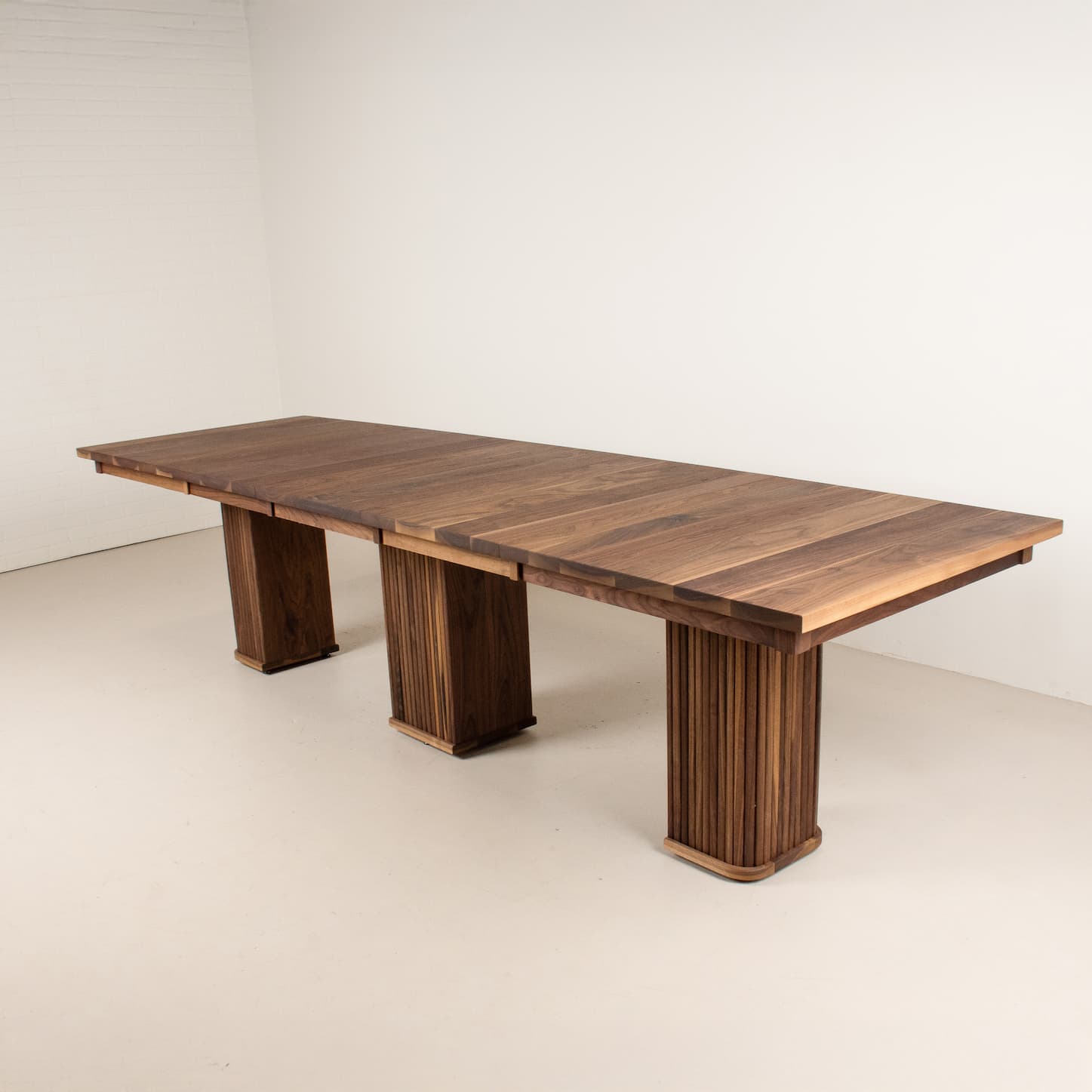 extendable walnut table on 3 part pedestal base