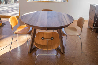 walnut round center extension table on chevron legs