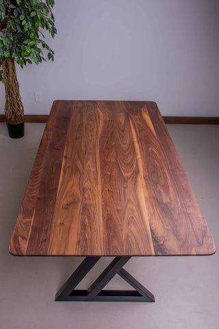 walnut table with nakina edge on steel legs