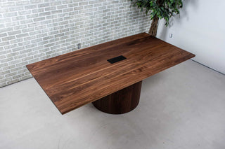 walnut conference table with hole for power supply on pedestal base