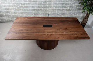 walnut conference table with hole for power supply on pedestal base