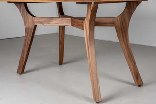 modern style walnut table in squoval shape on walnut legs