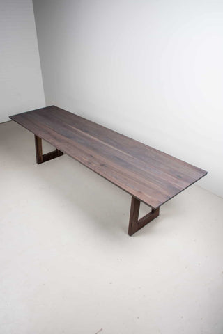 weathered walnut dining table on wood legs