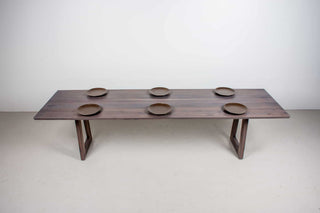 weathered walnut dining table on matching walnut trapezoid legs