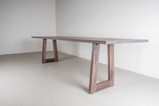 weathered walnut dining table on matching walnut trapezoid legs