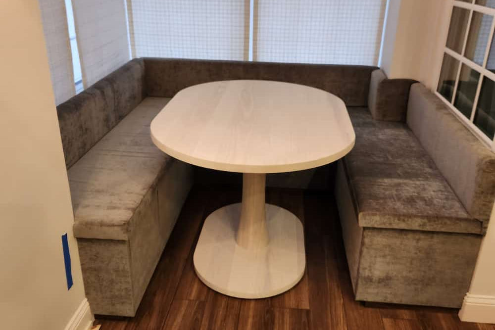 white ash oval table for a banquette