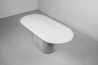 oval pedestal dining table made of ash wood finished in white