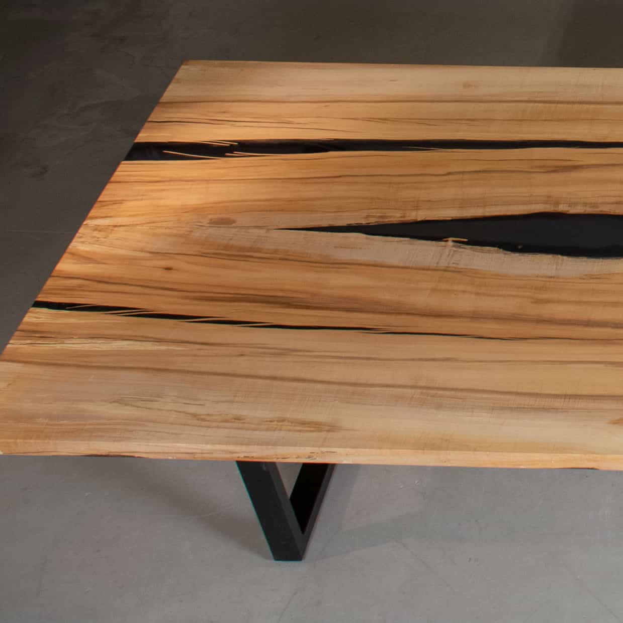 end of long maple table with epoxy